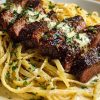 Cajun Garlic Butter Steak over Creamy Parmesan Linguine