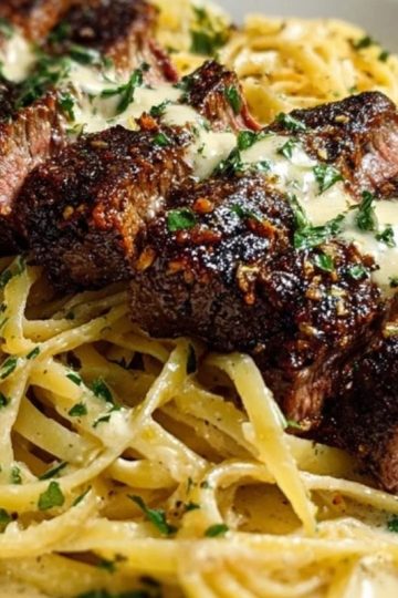 Cajun Garlic Butter Steak over Creamy Parmesan Linguine